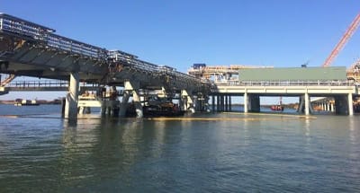 Floating containment boom deployed to contain an oil spill on water