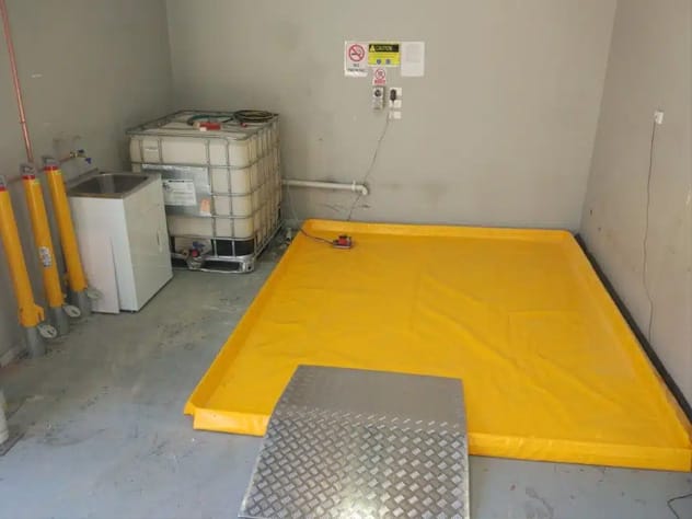 Portable wash bay installed indoors for contained vehicle washdown