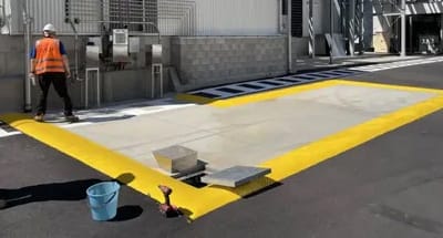 Rubber floor bunding forming a spill containment area in an industrial wash bay