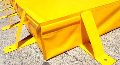 Close-up of portable bunding showing fold-out leg supports and reinforced wall construction