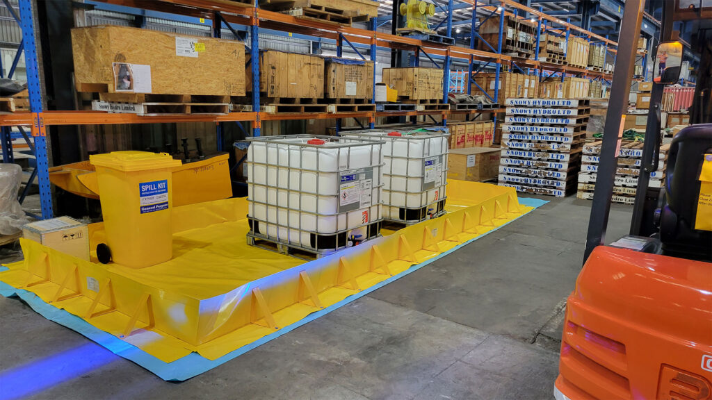 Portable bunding deployed around intermediate bulk containers at an industrial site